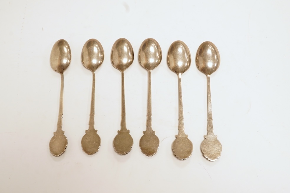 A matched set of six mainly George V silver/white metal and enamel teaspoons, with terminals decorated with dog's heads, 13.6cm. Condition - fair